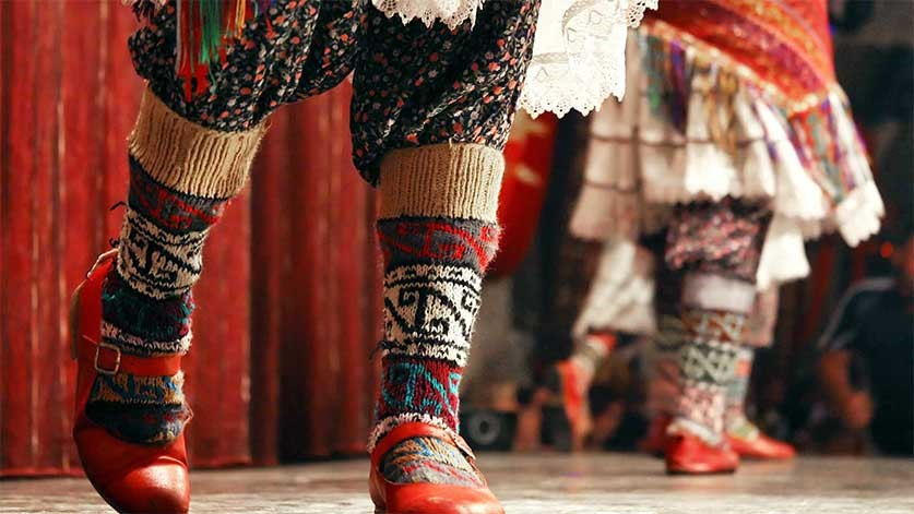 Red shoes and wool socks of a folklore dancer
